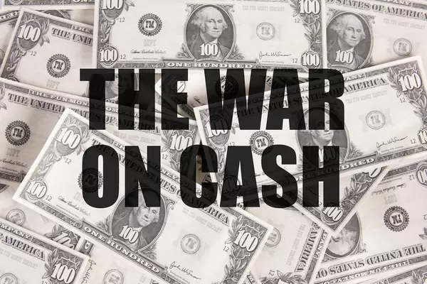 Dollar banknotes with The war on cash text