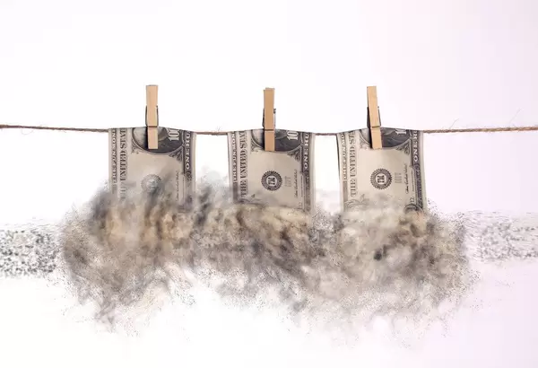 Dollar bills with smoke hanging on a clothes line