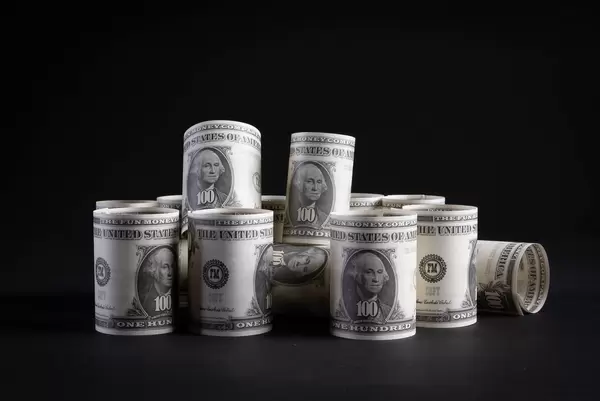 Dollar money banknotes rolls on black background