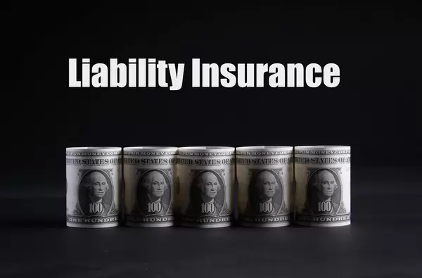 Dollar money banknotes rolls with Liability Insurance text