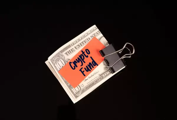 Dollars in money clip with Crypto Fund text