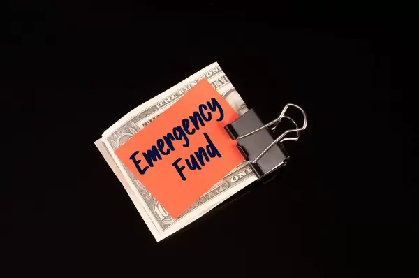 Dollars in money clip with Emergency Fund text