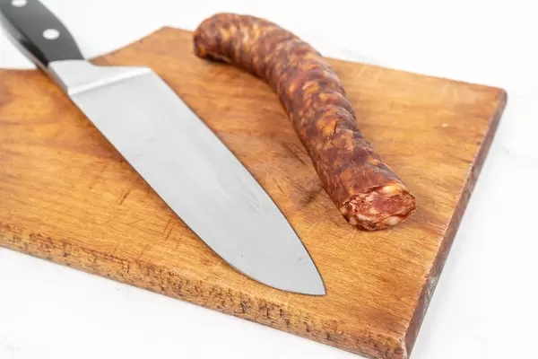 Domestic Homemade pork meat Sausage with knife on the cutting board (Flip 2019)