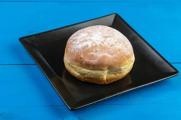 Donut with Powdered Sugar on the black square plate