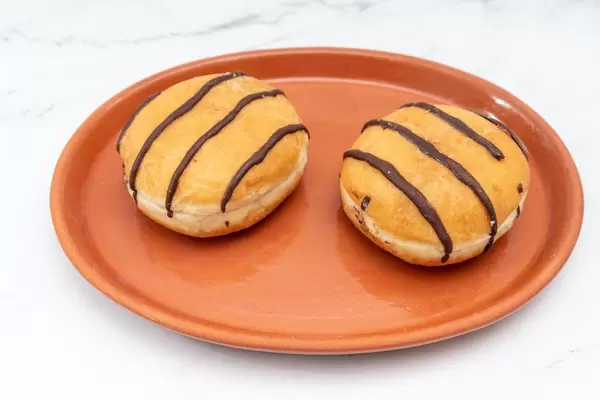 Donuts with Chocolate topping served on the plate