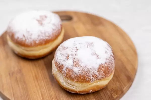 Donuts with Powdered Sugar on the wooden board