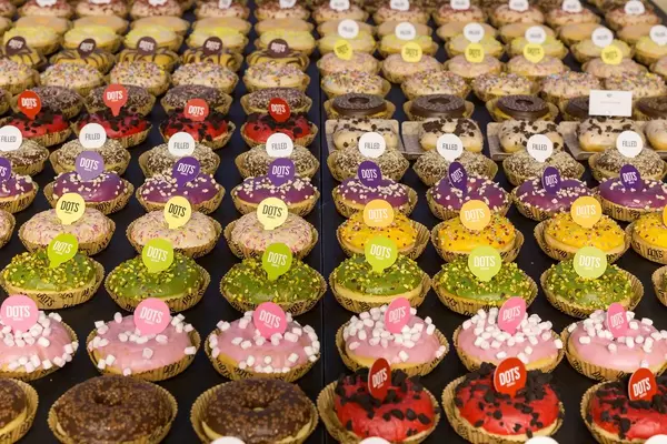 Dots Original Doughnuts with different flavors and bright colors