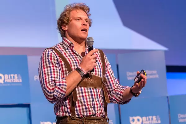 Dr. Julian Hosp explains a matter on stage