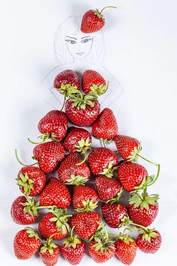 Drawing of a girl in a dress made of natural fresh strawberries