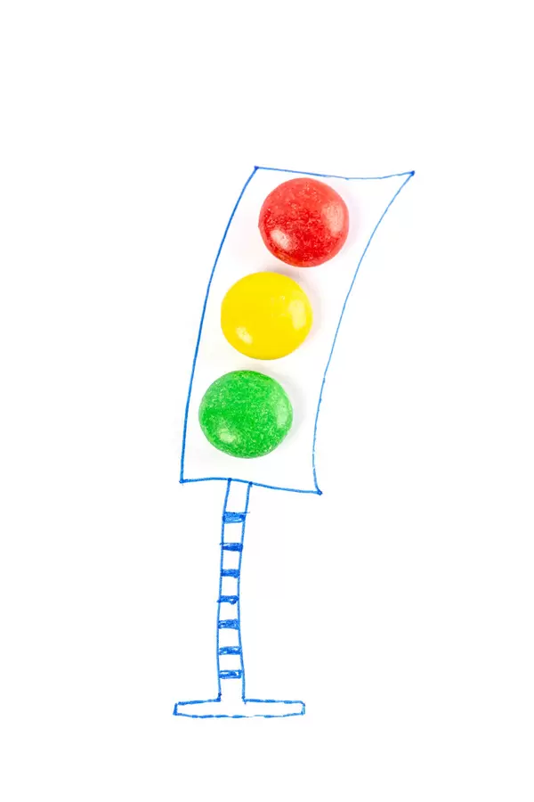 Drawn traffic light with colored candies instead of lamps