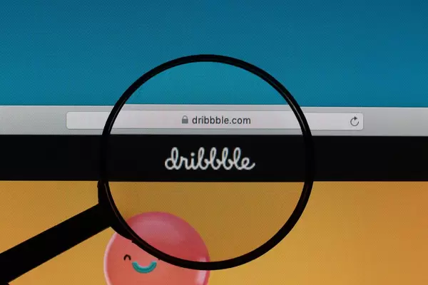 Dribbble logo under magnifying glass