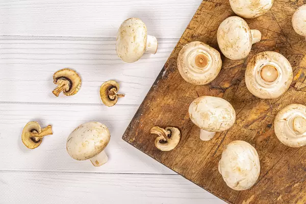 Dried champignons slices and fresh mushrooms, top view