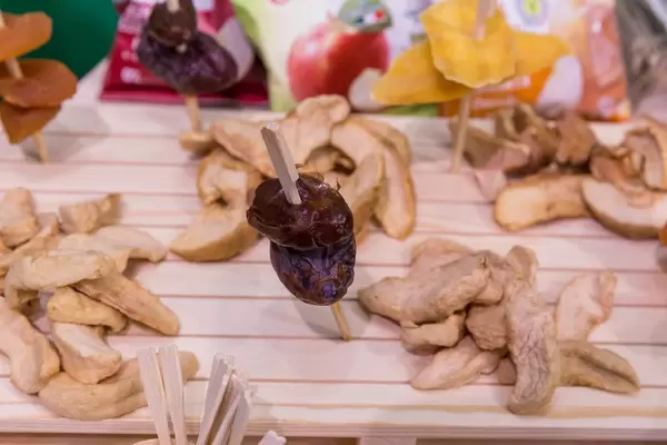 Dried fruit on display on a wooden board at the Noberasco stand at the Anuga food fair in Cologne, Germany