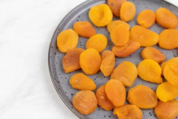 Dried Peaches on the plate with copy space