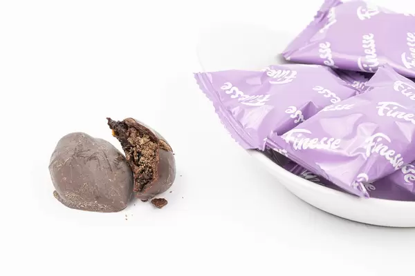 Dried Plums in Chocolate above white background