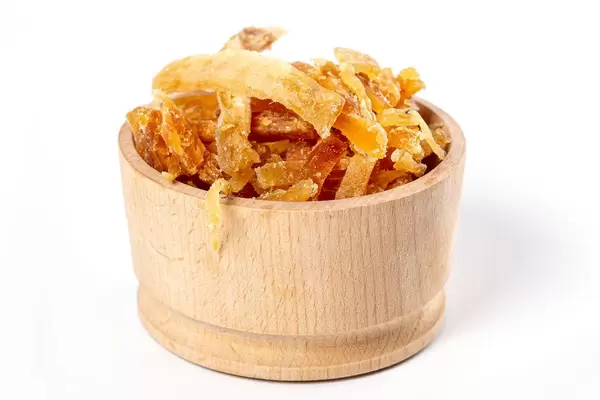 Dried salted tuna meat strips in wooden bowl on white