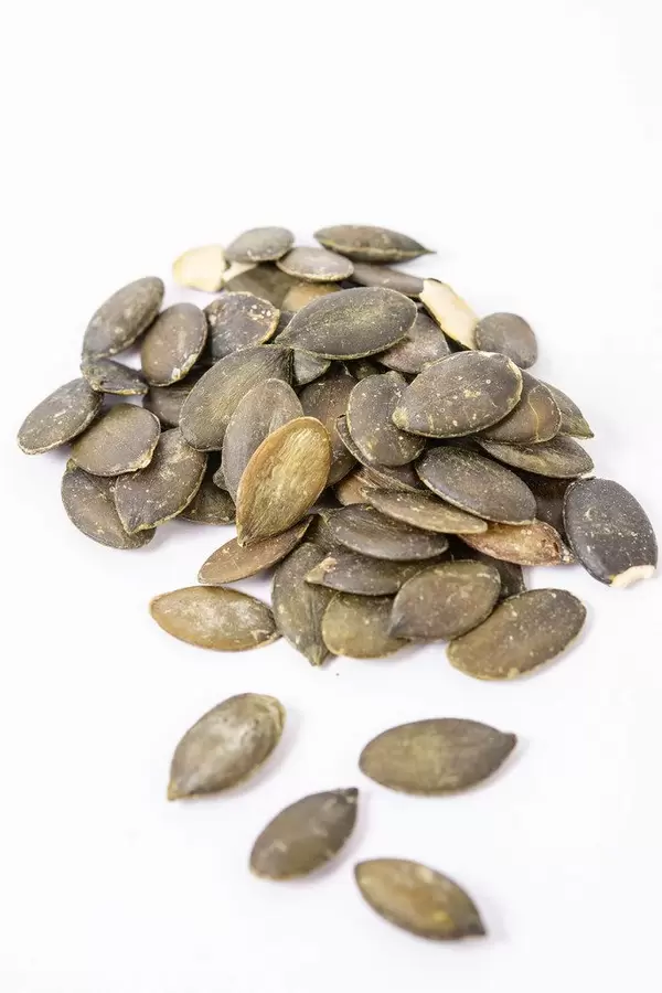Dried saulty Pumpkin Seeds above white background (Flip 2019)