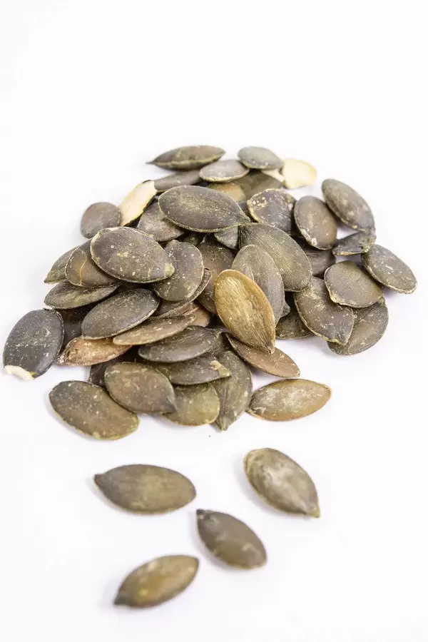 Dried saulty Pumpkin Seeds above white background