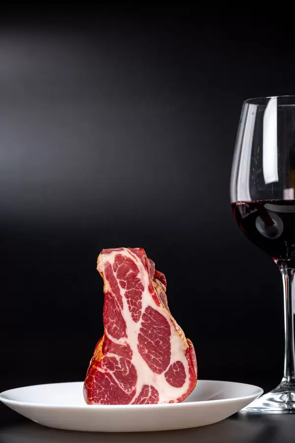 Dried smoked meat with a glass of red wine