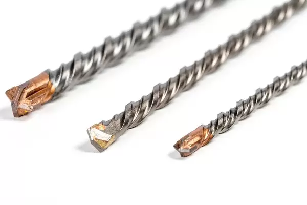 Drill bits of different sizes on white background (Flip 2020)