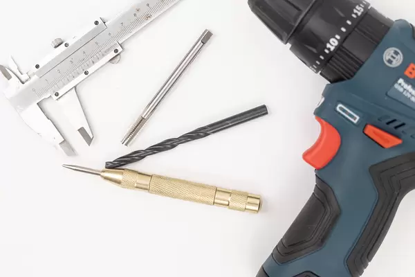 Drill with Tools isolated above white background