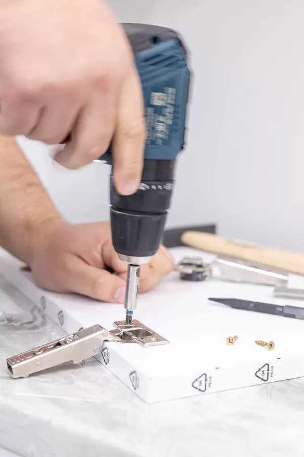 Drilling and Screwing screws in to cabinet door hinges