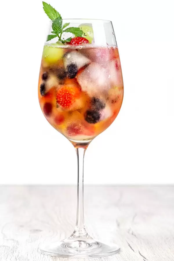 Drink glass with fruit ice and mint leaves
