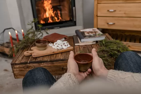 Drinking Hot Tea Near Fireplace