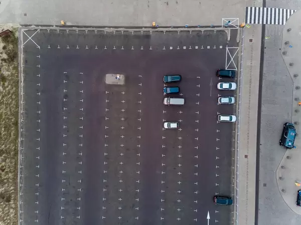 Drohnenaufnahme von Platz mit unzähligen, fast unbenutzten Parkplätzen