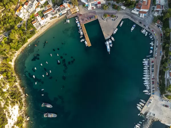 Drone image of the harbour and bay of Patitiri with docked boats on Alonnisos, Northern Sporades