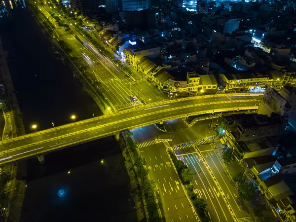 Drone Night Photo of Ong Lanh Bridge over Saigon River with less traffic due to a Lockdown in Ho Chi Minh City, Vietnam