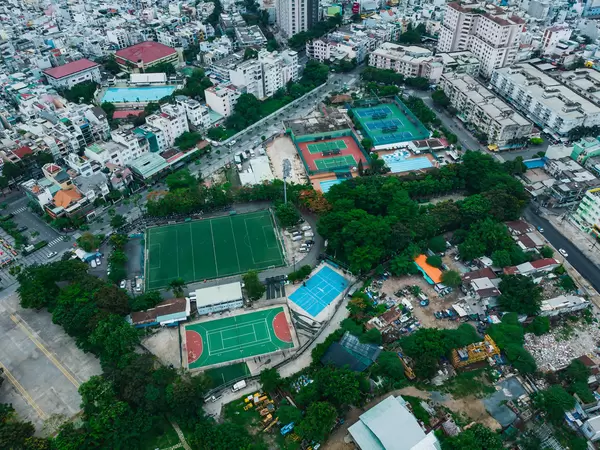 Drone Photo of a Sports Ground with Football Field, Tennis Courts and Outdoor Swimming Pool in District 4 in Ho Chi Minh City, Vietnam