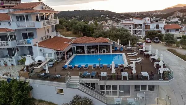 Drone photography while standing by the hotel pool on holiday in Greece