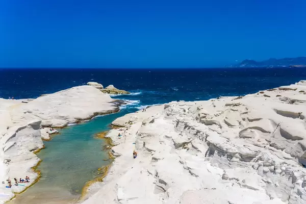 Drone pic: the white volcanic coast of Sarakiniko, Milos, Greece, with rocks shaped by waves and wind