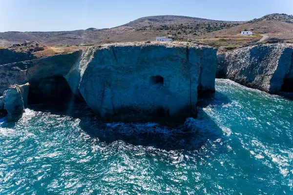 Drone pic: the wild, rough landscape of Papafrangas with high cliffs and just a few houses by the sea