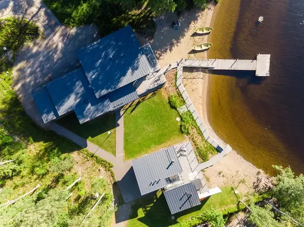 Drone picture of luxury apartment Villa Jolla in Padasjoki, Finland, with own wooden jetty and beach section at Lake Päijänne