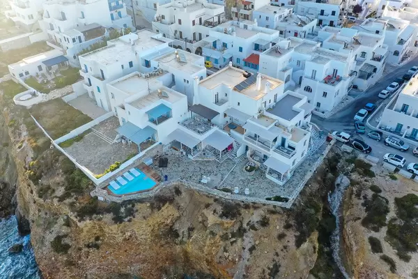Drone shot from the Iliada Sunset Suites complex in Naxos. Hotel with a pool on the edge of the cliff
