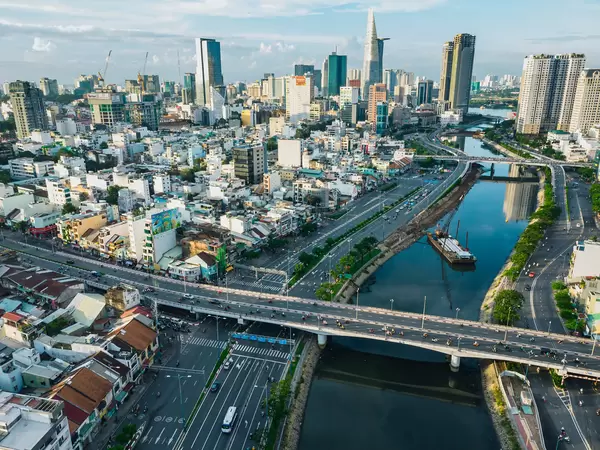 Drone Shot of Traffic on Bridges over Saigon River with the City Skyline in the Background in Ho Chi Minh City, Vietnam