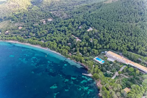 Drone shot: the world famous Formentor Royal Hideway Hotel surrounded by pine trees on Majorca