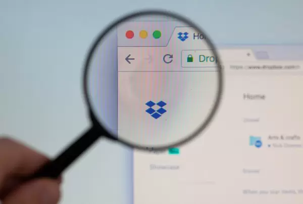 Dropbox logo on a computer screen with a magnifying glass