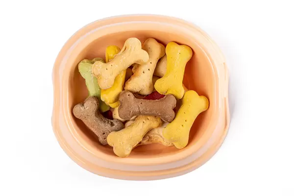 Dry dog food in the shape of the bones in a bowl