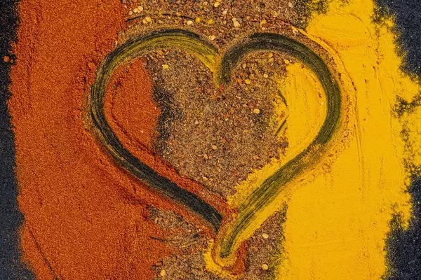 Dry spice mix with heart in the middle, top view