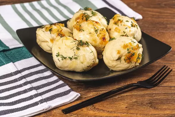 Dumplings with potatoes, fried onions and dill