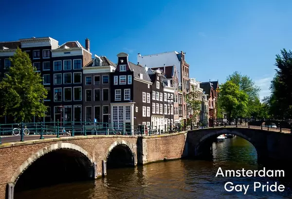 Dutch Capital city with old bridges and canal in the sun, next to title Amsterdam Gay Pride