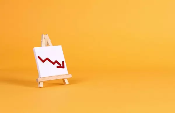 Easel with a red down arrow on orange background