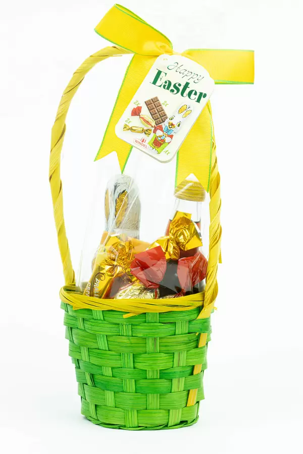 Easter eggs and chocolate in the woven basket