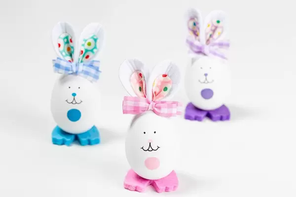 Easter eggs decorated like rabbits with ears. Holiday background