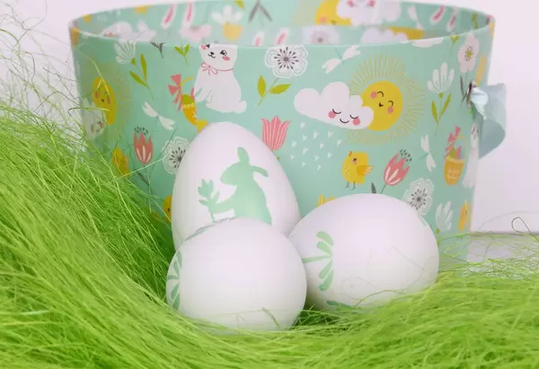 Easter eggs on green grass with basket