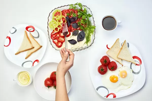 Eating fresh salad with organic vegetables and poached egg