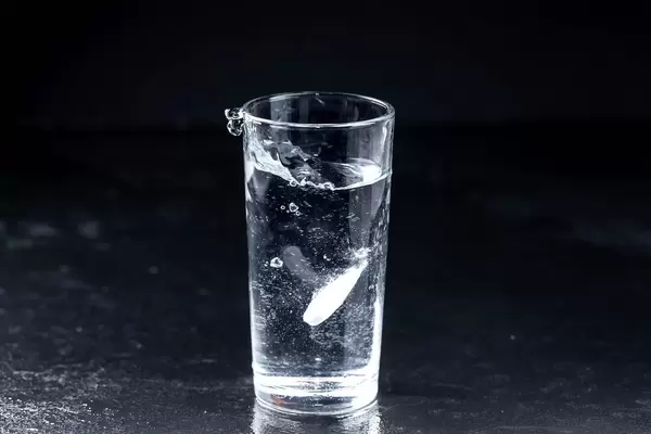 Effervescent tablet falls in a water glass